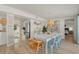 Open concept dining area with white table and light blue chairs, kitchen and bedroom views at 2069 Bougainvillea St, Sarasota, FL 34239