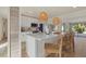 Modern kitchen with white cabinets, island, and wood floors at 2069 Bougainvillea St, Sarasota, FL 34239