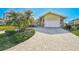 House exterior featuring a large garage and manicured landscaping at 219 Keel Way, Osprey, FL 34229