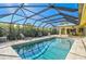 Relaxing screened-in pool area with lounge chairs and patio furniture at 219 Keel Way, Osprey, FL 34229