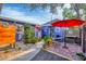 Small patio area with seating and red umbrella at 3219 S East Ave, Sarasota, FL 34239