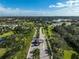 Gated community entrance with palm trees and lush landscaping at 3970 Prairie Dunes Dr, Sarasota, FL 34238