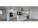 Modern kitchen featuring white cabinets, a large island, and stainless steel appliances at 4007 Asbury Pl, Sarasota, FL 34233