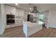 Modern kitchen with white cabinets, large island, and stainless steel appliances at 4007 Asbury Pl, Sarasota, FL 34233