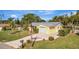 Nice yellow house with gray metal roof, palm trees, and well-manicured lawn at 409 Archibald Ave, Sarasota, FL 34243