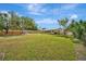 Large backyard with spacious grassy area and wooden fence at 409 Archibald Ave, Sarasota, FL 34243