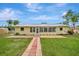 Large backyard with patio, walkway, and sunroom at 409 Archibald Ave, Sarasota, FL 34243