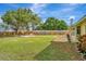 Spacious backyard with patio, grassy area, and shade tree at 409 Archibald Ave, Sarasota, FL 34243