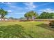 Large backyard with grassy area, wooden fence, and shade tree at 409 Archibald Ave, Sarasota, FL 34243