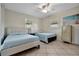 Bedroom with two twin beds, dresser, and large windows at 409 Archibald Ave, Sarasota, FL 34243