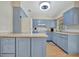 Updated kitchen with light blue cabinets, white appliances, and light countertops at 409 Archibald Ave, Sarasota, FL 34243