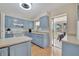 Updated kitchen with light blue cabinets, white appliances, and access to a patio at 409 Archibald Ave, Sarasota, FL 34243