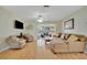 Spacious living room with hardwood floors and access to a screened porch at 409 Archibald Ave, Sarasota, FL 34243
