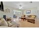 Bright living room with hardwood floors, sectional sofa, and screened porch view at 409 Archibald Ave, Sarasota, FL 34243