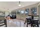 Bright sunroom with tiled floor, comfy seating, and access to backyard at 409 Archibald Ave, Sarasota, FL 34243