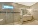 Spa-like bathroom with a walk-in shower, double vanity, and modern fixtures at 4730 Zeno Ct, Bradenton, FL 34211
