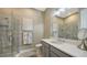 Bathroom with a walk-in shower, gray tile, and a white vanity at 4730 Zeno Ct, Bradenton, FL 34211