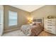 Bedroom with a queen bed, dresser, and window blinds at 4730 Zeno Ct, Bradenton, FL 34211