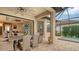 Spacious covered patio with dining area, outdoor kitchen, and comfortable seating at 4730 Zeno Ct, Bradenton, FL 34211