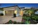 Inviting home exterior with a two-car garage and landscaped yard at 4730 Zeno Ct, Bradenton, FL 34211