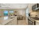 Modern kitchen with island, stainless steel appliances and granite countertops at 4730 Zeno Ct, Bradenton, FL 34211