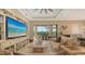 Spacious living room with large TV and access to a lanai and pool at 4730 Zeno Ct, Bradenton, FL 34211