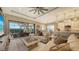 Bright and airy living room features a large TV and access to the lanai at 4730 Zeno Ct, Bradenton, FL 34211