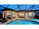 Inviting outdoor oasis with a pool, spa, and covered patio at 4730 Zeno Ct, Bradenton, FL 34211