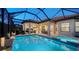 Inviting pool and spa with covered patio and outdoor kitchen at 4730 Zeno Ct, Bradenton, FL 34211