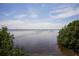 Scenic waterfront view with calm water and lush greenery at 5415 Title Row Dr, Bradenton, FL 34210