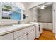 Laundry room with white cabinets, granite countertops, and a washer and dryer at 780 Rellim Ln, Sarasota, FL 34232