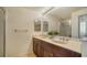 Bathroom with double sinks and a walk-in shower at 800 N Tamiami Trl # 403, Sarasota, FL 34236
