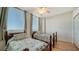 Two twin beds in a well-lit guest bedroom at 800 N Tamiami Trl # 403, Sarasota, FL 34236