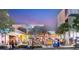 Rosemary District at night, showing outdoor seating areas and people enjoying the vibrant atmosphere at 800 N Tamiami Trl # 403, Sarasota, FL 34236
