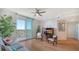 Living room with hardwood floors, comfortable seating, and sliding doors to balcony at 800 N Tamiami Trl # 403, Sarasota, FL 34236
