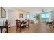 Light-filled living room with hardwood floors, dining area, and balcony access at 800 N Tamiami Trl # 403, Sarasota, FL 34236