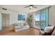 Living area features hardwood floors, a comfy sofa, and views of the water at 800 N Tamiami Trl # 403, Sarasota, FL 34236