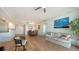 Spacious living room with hardwood floors, and a view of the dining area and kitchen at 800 N Tamiami Trl # 403, Sarasota, FL 34236