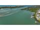 Aerial view of waterfront property with boats and lush greenery at 85 Sugar Mill Dr, Osprey, FL 34229