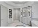 Spa-like bathroom with a walk-in shower, marble finishes, and ample storage at 85 Sugar Mill Dr, Osprey, FL 34229