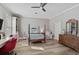 Spacious bedroom with a desk area, hardwood floors, and a comfortable bed at 85 Sugar Mill Dr, Osprey, FL 34229