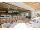 Community clubhouse bar with indoor and outdoor seating and large screen TVs at 85 Sugar Mill Dr, Osprey, FL 34229