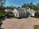 Gray house with tile roof, large driveway, and lush landscaping at 85 Sugar Mill Dr, Osprey, FL 34229