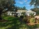 Beautiful one-story home with lush landscaping and a large lawn at 85 Sugar Mill Dr, Osprey, FL 34229