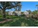 House exterior, manicured lawn, and large tree in front at 85 Sugar Mill Dr, Osprey, FL 34229