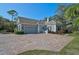 Gray house with tile roof and a large brick paver driveway at 85 Sugar Mill Dr, Osprey, FL 34229