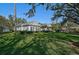 Landscaped front yard with mature trees and lush greenery at 85 Sugar Mill Dr, Osprey, FL 34229