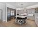 Modern kitchen with large island, stainless steel appliances, and hardwood floors at 85 Sugar Mill Dr, Osprey, FL 34229