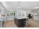 Open kitchen boasts white cabinets, a large island, and a farmhouse sink at 85 Sugar Mill Dr, Osprey, FL 34229