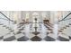 Lobby with checkerboard floor, white columns, and comfortable seating at 85 Sugar Mill Dr, Osprey, FL 34229